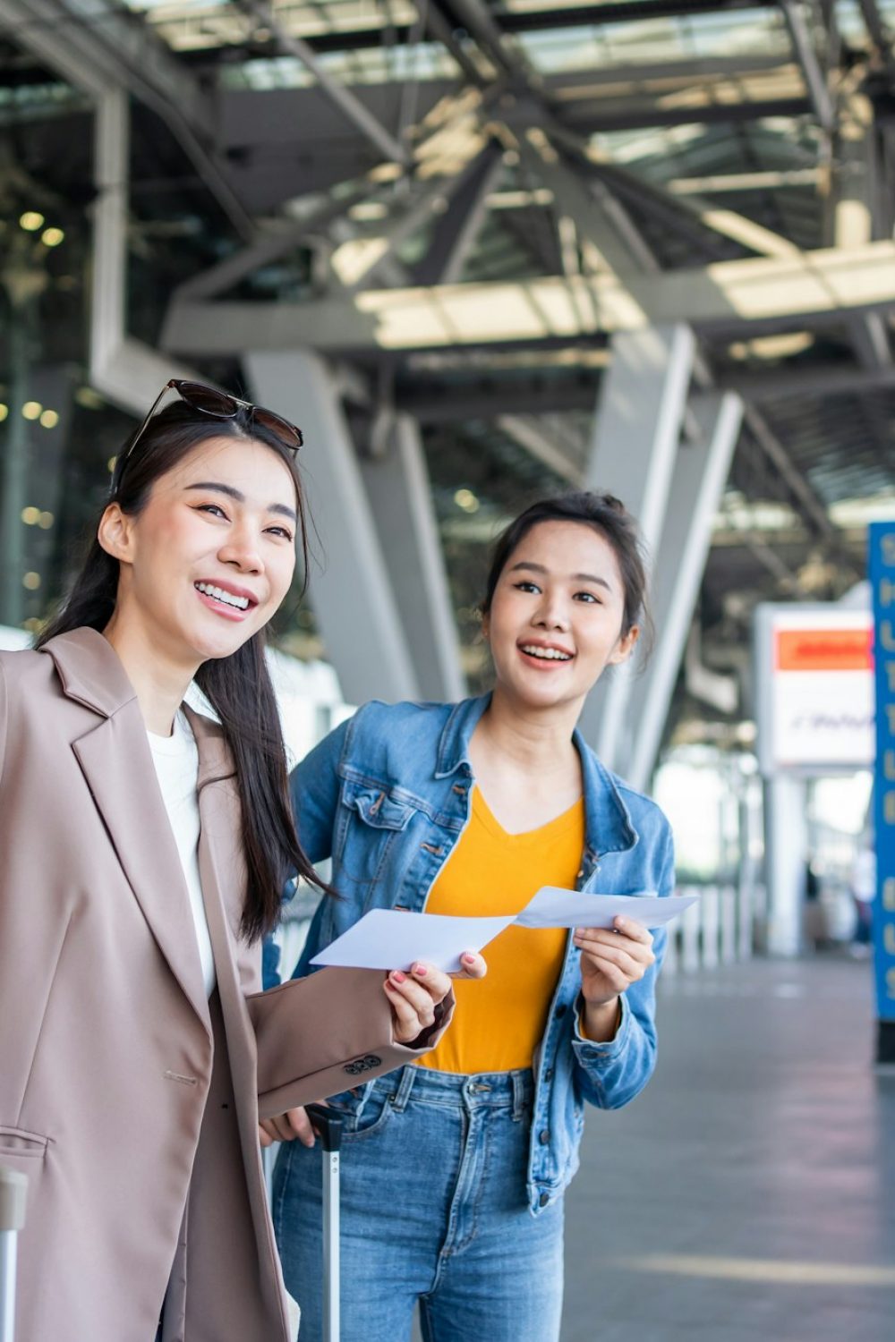 Asian two women passenger waiting a bus after leaving from the airport.